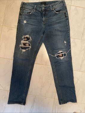 Silver Jeans Dark Blue Distressed Slim with Floral Patches.